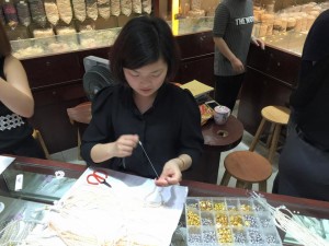 The lady at the market stringing Lily's pearls